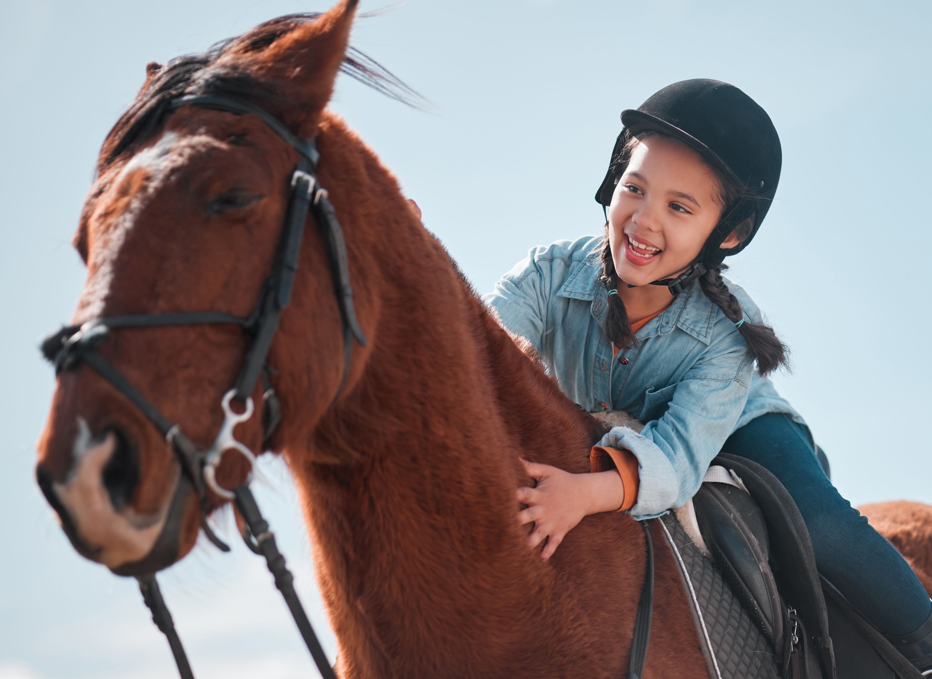 Shot of an adorable little girl riding a horse